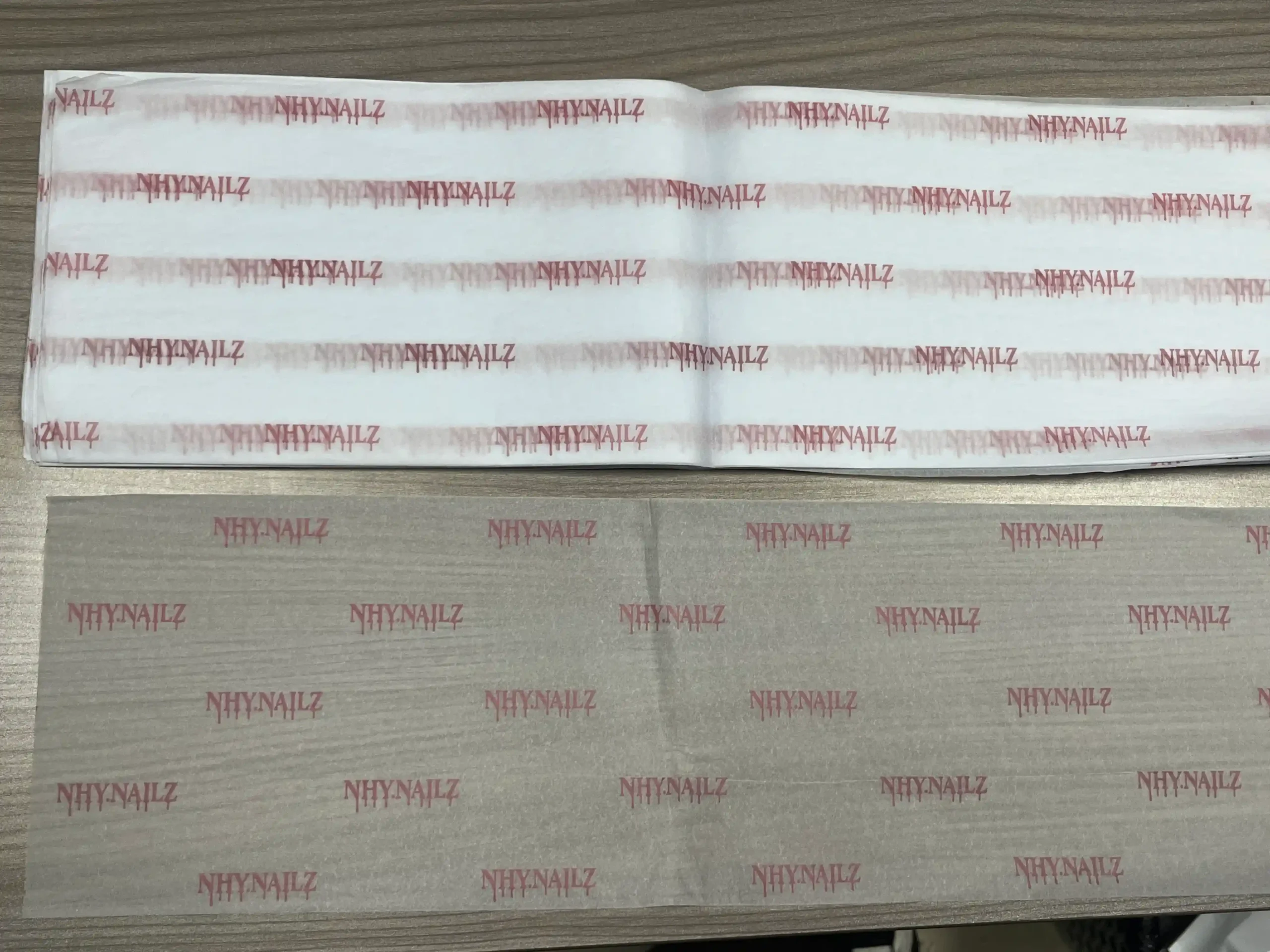 White tissue paper with pink nail brand logos